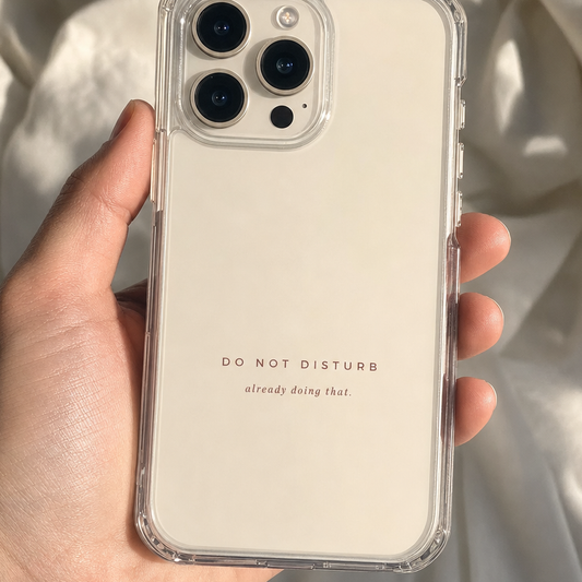 Clear iPhone case printed “Do Not Disturb, already doing that” in dark rose lettering