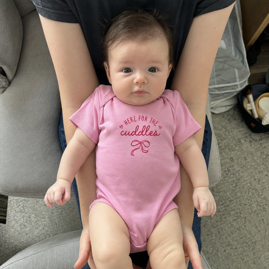 Here for the Cuddles baby bodysuit worn