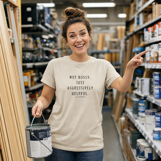 Not Bossy Just Aggressively Helpful tee worn in a hardware shop aisle