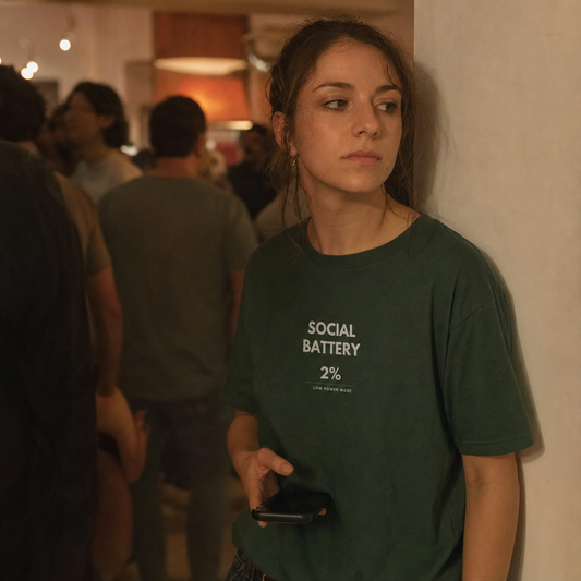 Social Battery tee worn at a crowded party
