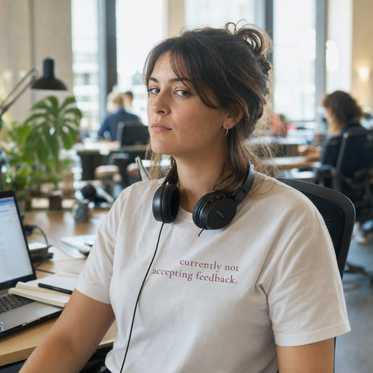 Currently Not Accepting Feedback tee worn at a desk in a shared workspace