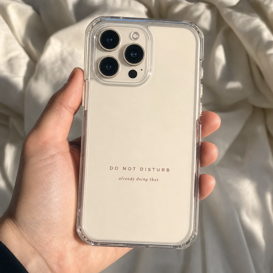 Clear iPhone case printed “Do Not Disturb, already doing that” in dark rose lettering