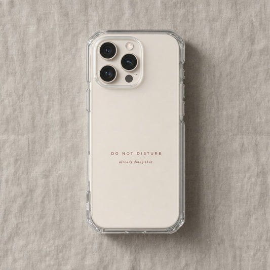 Clear iPhone case printed “Do Not Disturb, already doing that” in dark rose lettering